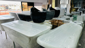 modern sanitary ware, including black and white freestanding soaking bathtubs and ceramic washbasins