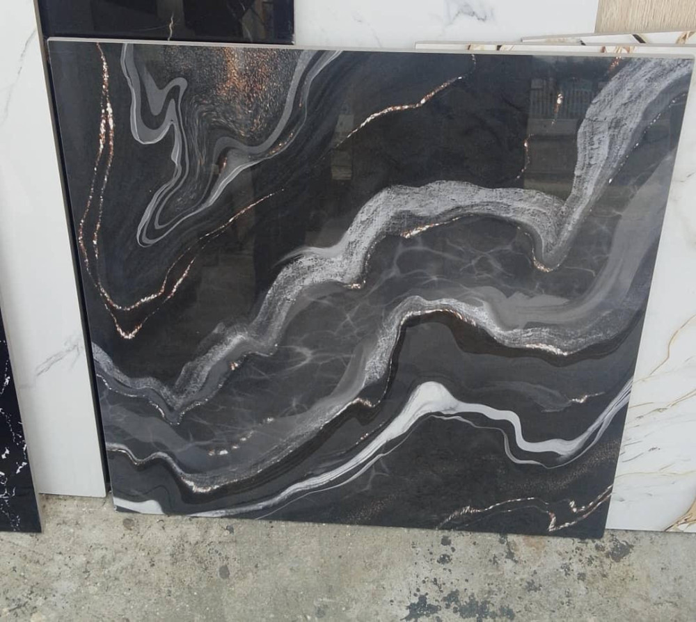 Polished porcelian floor tile featuring a black arble design with a white and gold veins