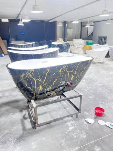 Luxury freestanding solid surface bathtub featuring a black and gold marble pattern finish