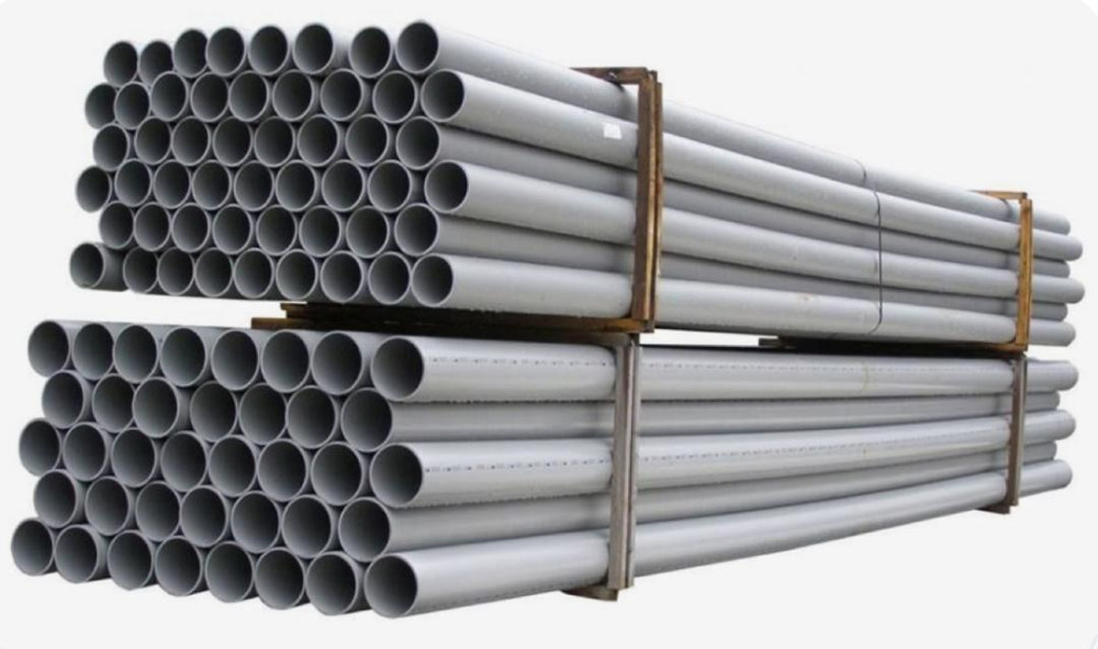 bundles of grey PVC pipes typically used in construction and plumbing