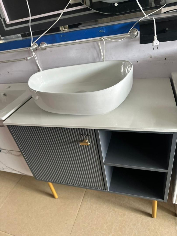 Bathroom vanity is a wall-hung(floating) unit with a marble-effect finish and modern black accents