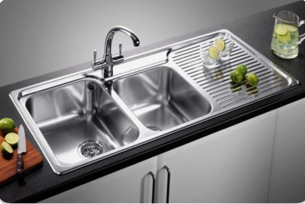 Stainless steel double bowl kitchen sink with an integrated drainer