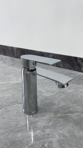 Modern brass sink  or basin mixer faucet wit a shiny chrome finish