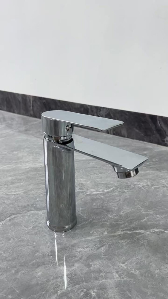 Modern brass sink  or basin mixer faucet wit a shiny chrome finish