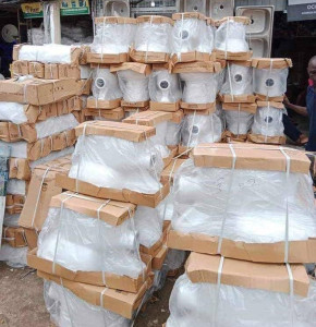 Sanitary wares specifically ceramic toilet bowls(water Closets) stacked in  a warehouse or market setting