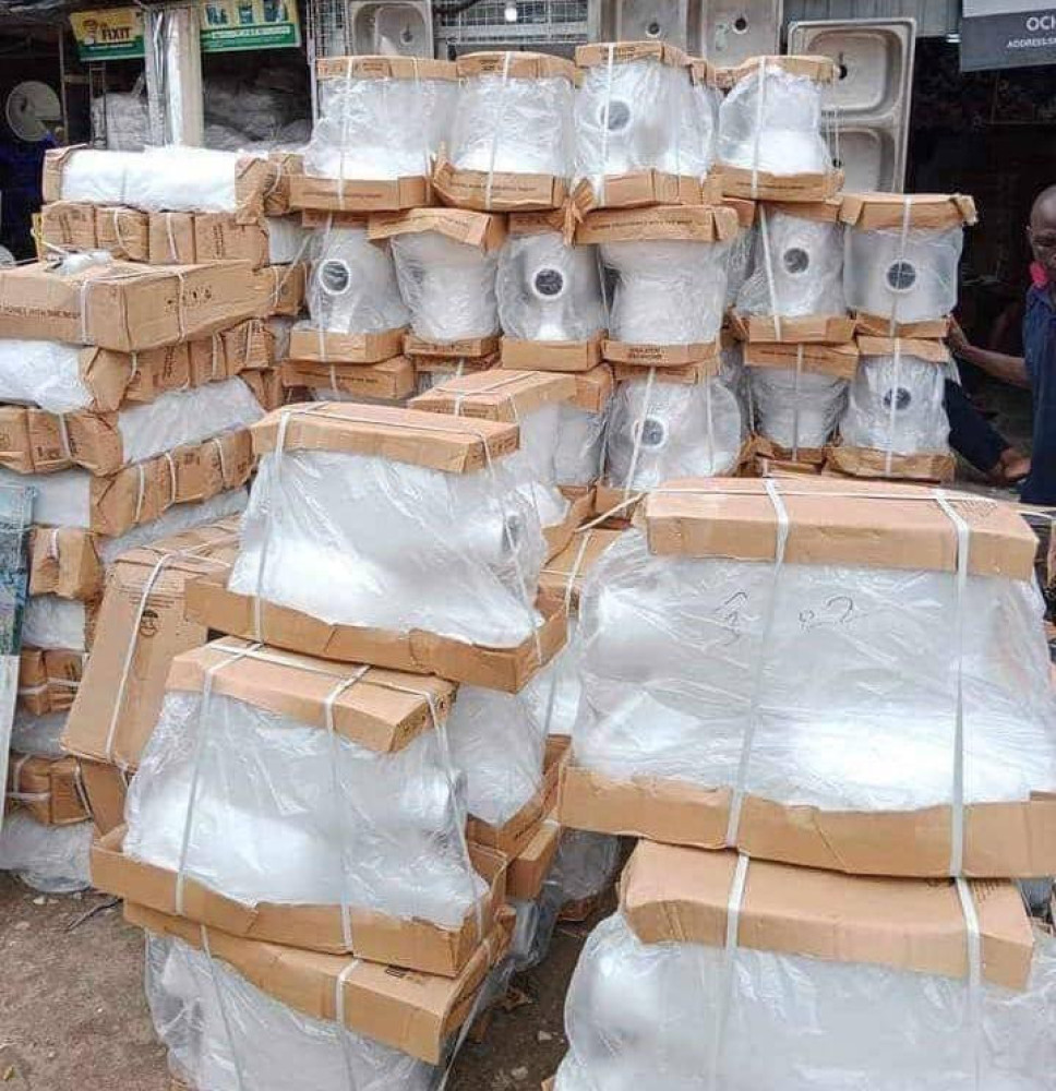 Sanitary wares specifically ceramic toilet bowls(water Closets) stacked in  a warehouse or market setting