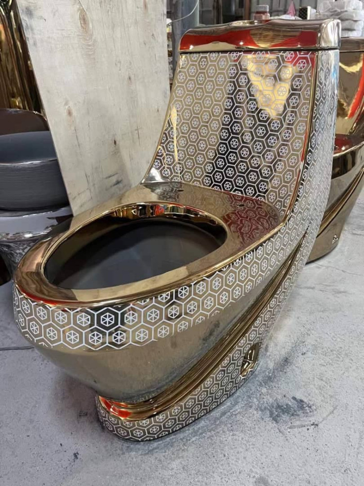 luxurious, gold-plated one-piece ceramic toilet bowl featuring a distinct hexgonal pattern
