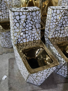 gold luxury floor-mounted ceramic one-piece toilet featuring a geometric design