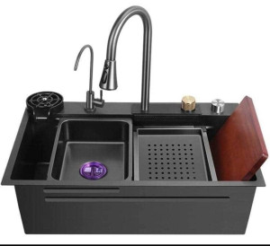 multifunctional black kitchen workstation sink, often referred to as water fall sink