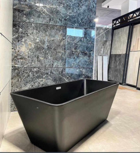 black freestanding bathtub commonly available in matte finishes and made from materials like acrylic or solid surface resin